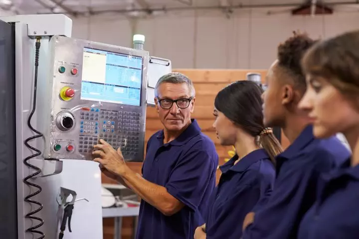 engineer training apprentices on cnc machine resized for webpage
